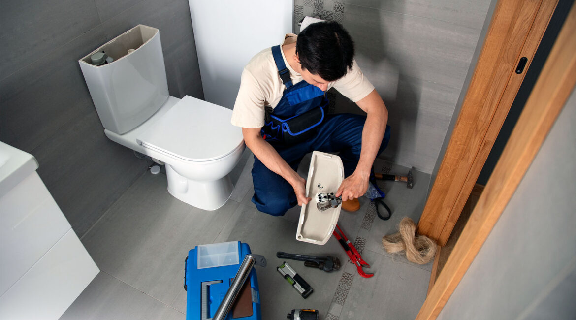 The 30-Minute Toilet Tune-Up Homeowner Performing 30-Minute Toilet Tune-Up Maintenance With Tools And Vinegar For Leak Testing