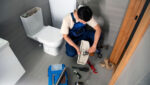 The 30-Minute Toilet Tune-Up Homeowner Performing 30-Minute Toilet Tune-Up Maintenance With Tools And Vinegar For Leak Testing