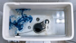 Running Toilet Fix: 30-Minute Repair Open Toilet Tank With Food Colouring Spreading Through The Water During A Running Toilet Dye Test