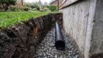 Weeping Tile: Signs Yours Has Failed Weeping Tile Pipe In An Excavated Foundation Trench, Bedded In Drain Rock Beside A Footing